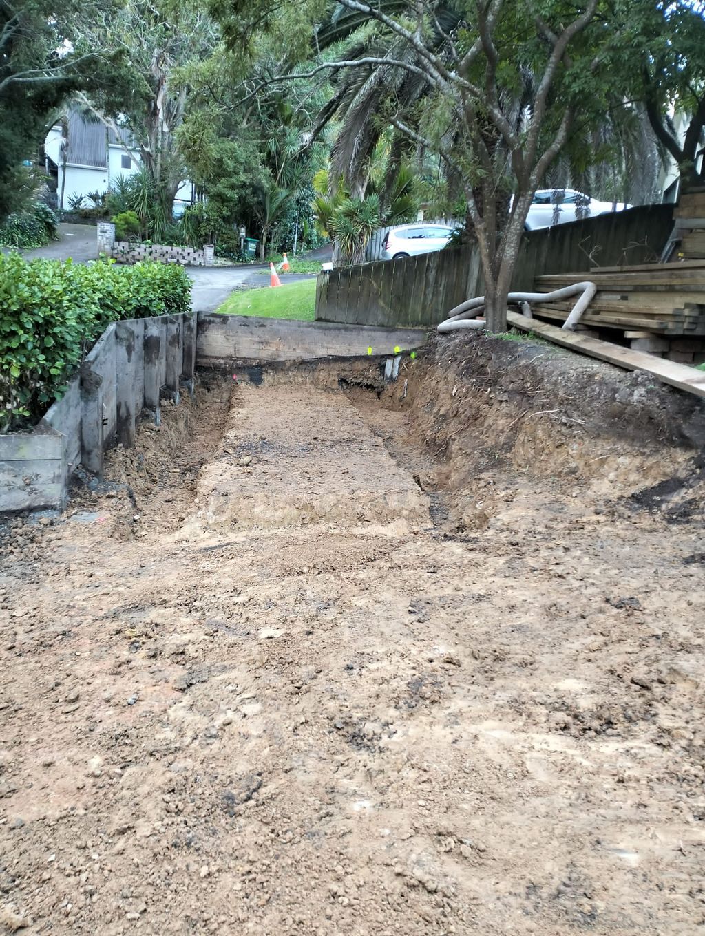 Excavated side-access area with exposed earth and timber edges