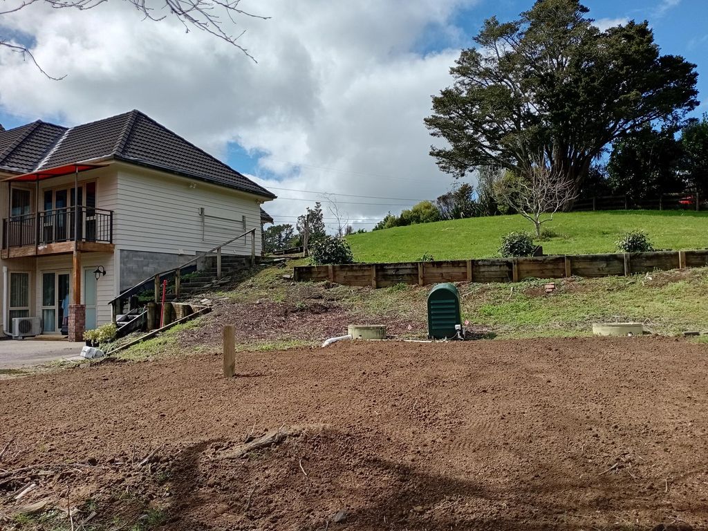 Graded ground beside a house and existing timber retaining wall
