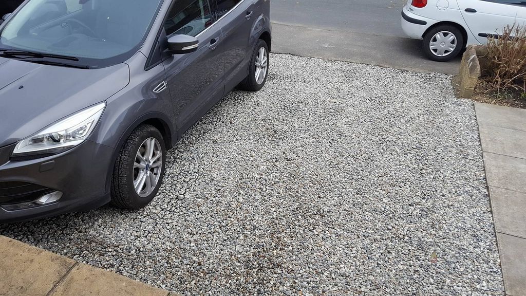 New gravel car pad laid beside a driveway