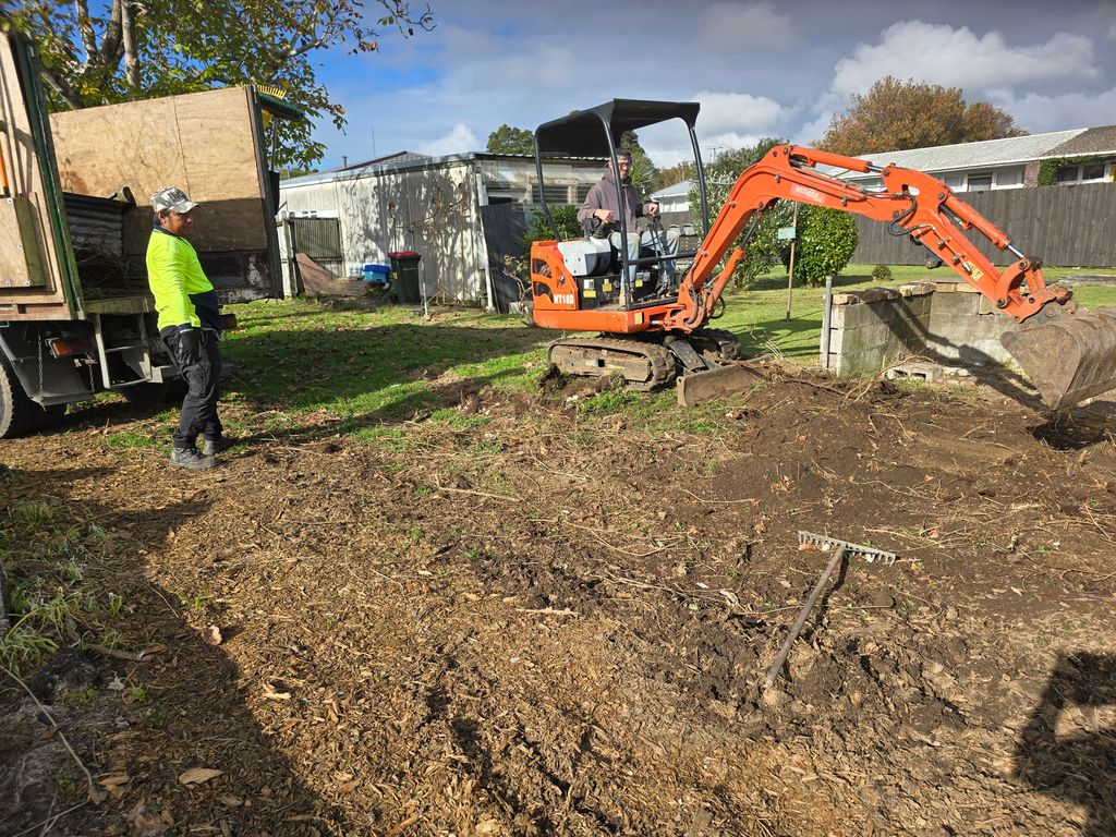 Mini digger and crew member working on a residential earthworks job